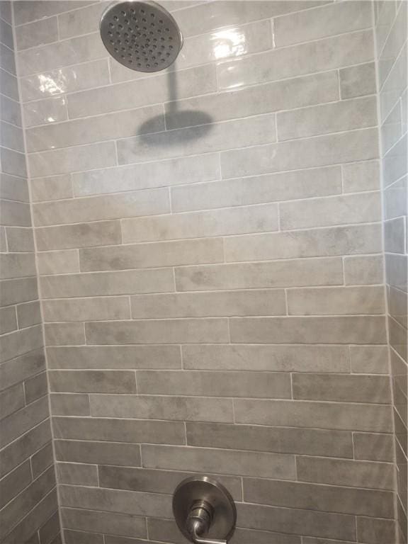 bathroom with a tile shower