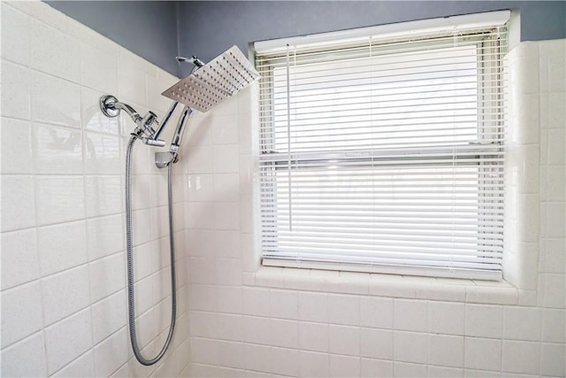 bathroom with a tile shower