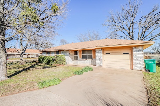 ranch-style house with concrete driveway, brick siding, an attached garage, and a front yard