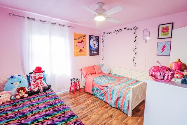 bedroom with a ceiling fan and wood finished floors