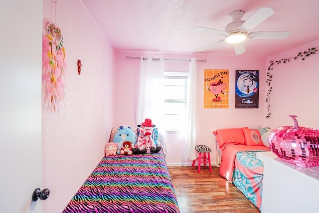 bedroom featuring wood finished floors and a ceiling fan