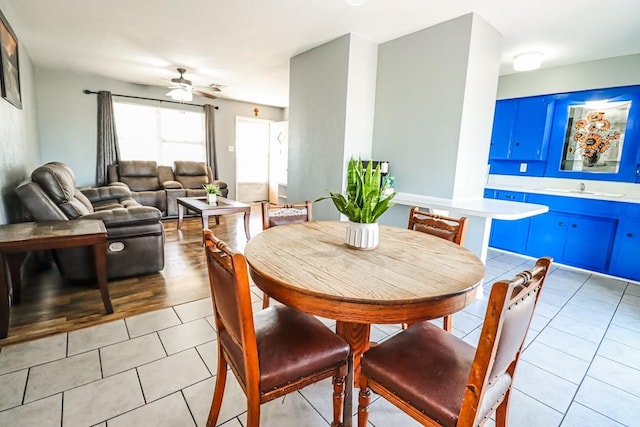 dining area with light tile patterned floors and a ceiling fan