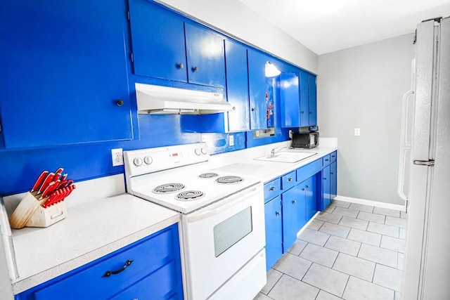 kitchen with white appliances, under cabinet range hood, and blue cabinetry