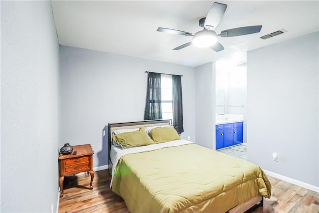 bedroom with baseboards, visible vents, ceiling fan, and light wood finished floors