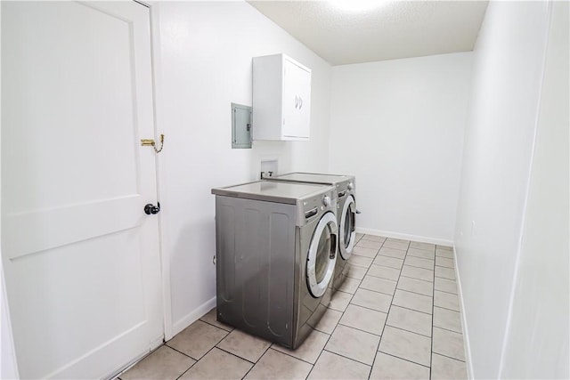 washroom with laundry area, electric panel, baseboards, washer and clothes dryer, and light tile patterned flooring