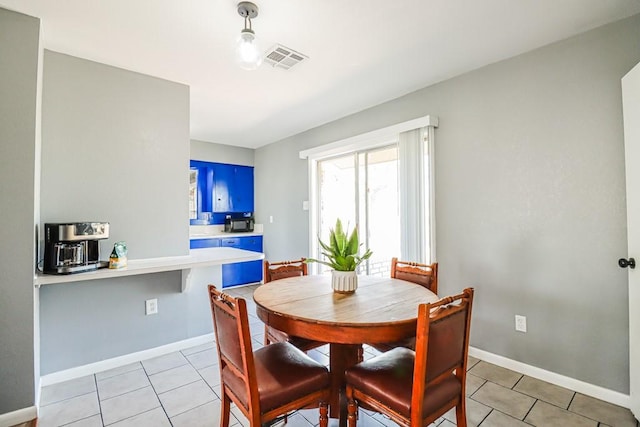 dining area with light tile patterned floors, baseboards, and visible vents