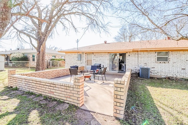 view of patio / terrace featuring central AC unit, a fire pit, and fence