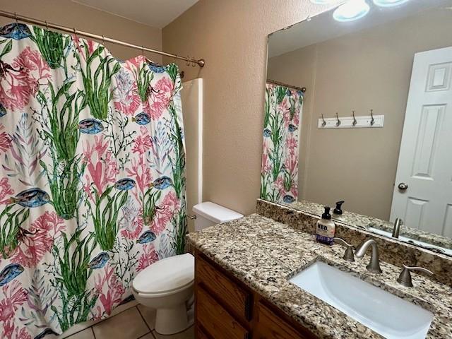 bathroom with vanity, tile patterned floors, and toilet