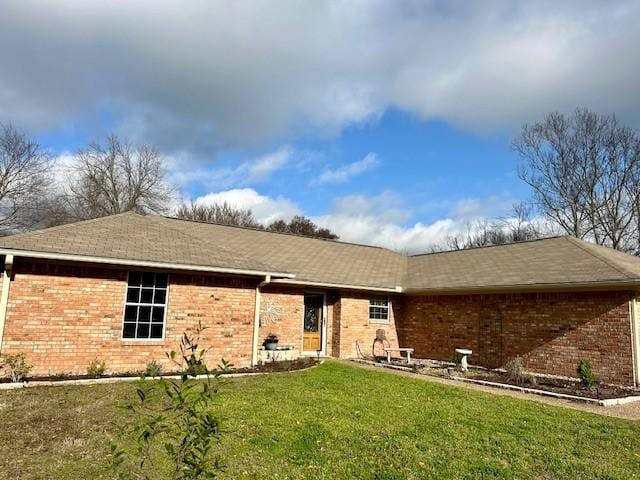 rear view of house with a yard