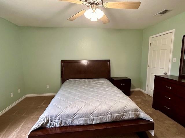 bedroom with dark carpet and ceiling fan