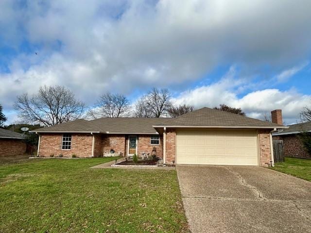 single story home with a garage and a front lawn