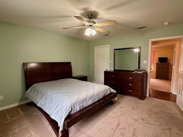 bedroom with light carpet and ceiling fan