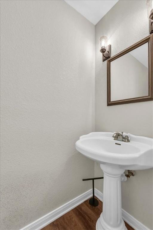 bathroom featuring baseboards and wood finished floors