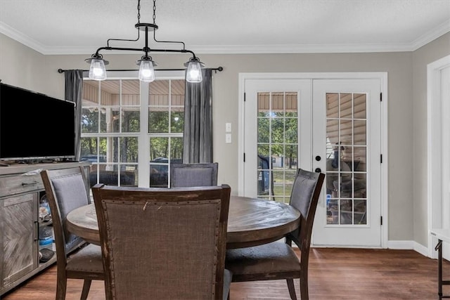 dining room featuring french doors, wood finished floors, a wealth of natural light, and ornamental molding