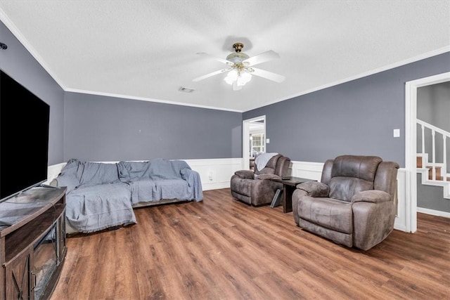 bedroom with visible vents, crown molding, and wood finished floors