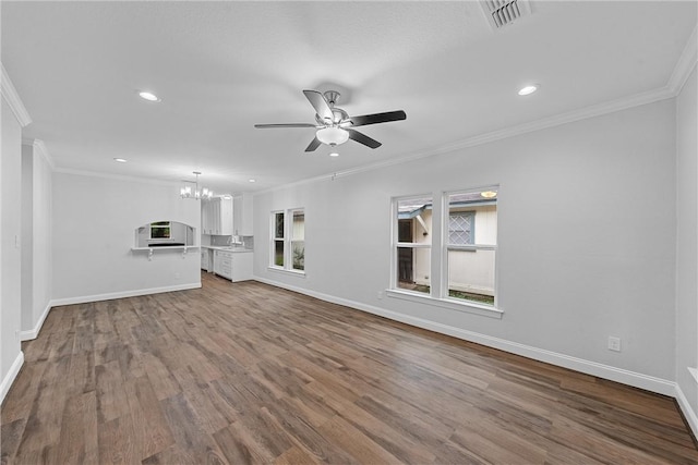 unfurnished living room with wood-type flooring, ceiling fan with notable chandelier, and ornamental molding