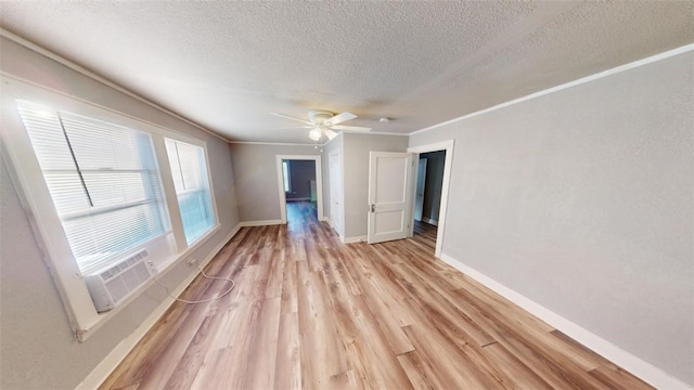 unfurnished room with ceiling fan, crown molding, cooling unit, a textured ceiling, and light wood-type flooring