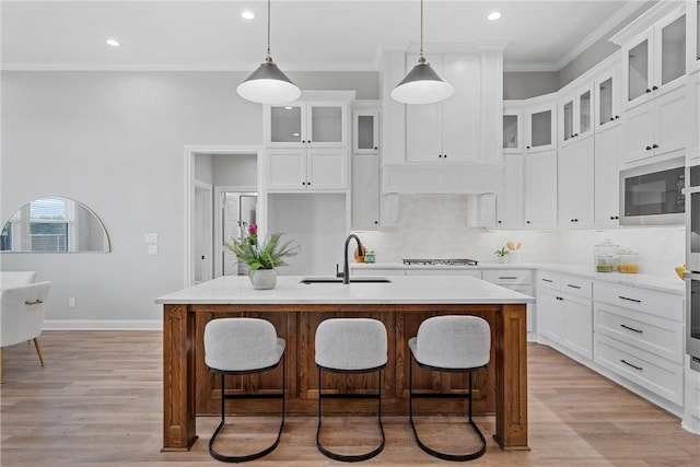 kitchen featuring light hardwood / wood-style flooring, sink, an island with sink, and stainless steel appliances