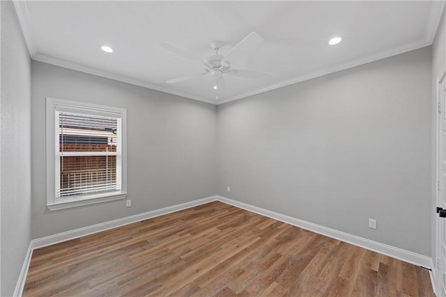 empty room featuring crown molding, ceiling fan, and wood-type flooring