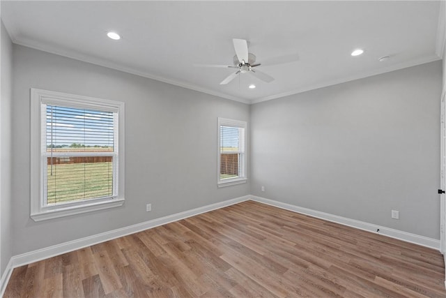 empty room featuring light hardwood / wood-style flooring, plenty of natural light, and ornamental molding