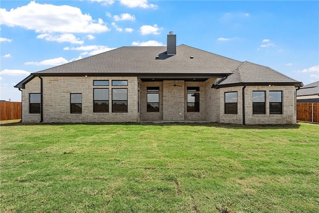 back of property featuring a lawn