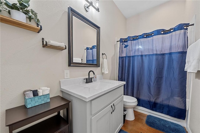 full bathroom with vanity, shower / bath combo, and toilet