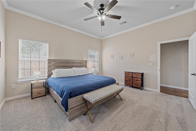 carpeted bedroom with ceiling fan and ornamental molding