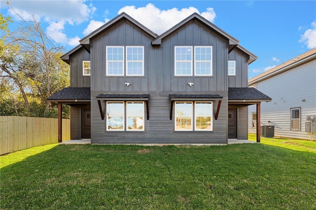 back of property with a lawn and central AC unit