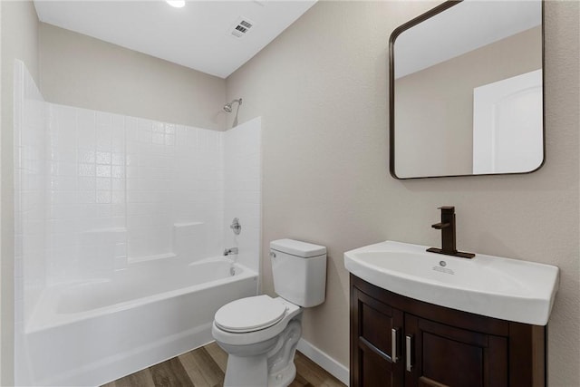 full bathroom featuring hardwood / wood-style floors, vanity, toilet, and tub / shower combination