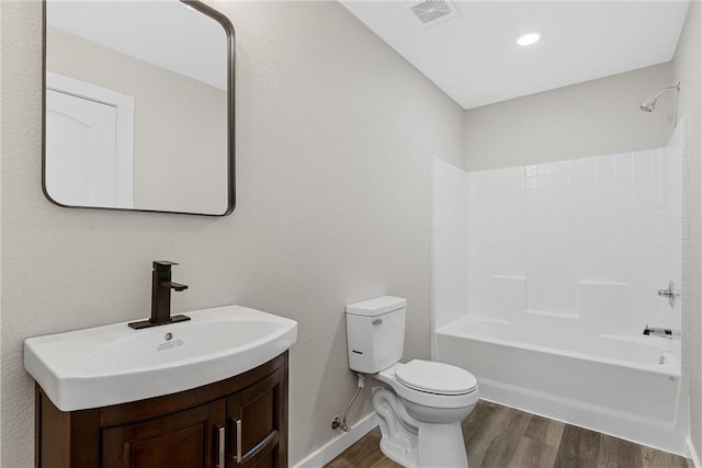 full bathroom with vanity, toilet, shower / bathing tub combination, and hardwood / wood-style flooring