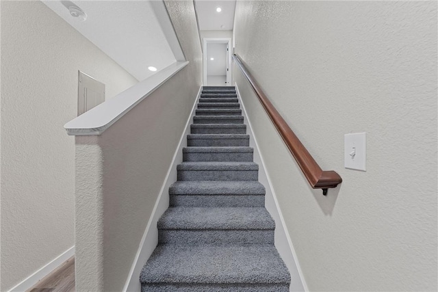 stairway with hardwood / wood-style flooring