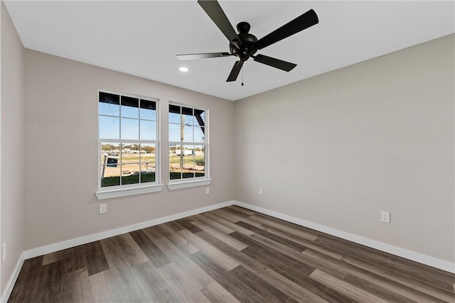 spare room with hardwood / wood-style flooring and ceiling fan