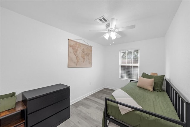 bedroom featuring visible vents, ceiling fan, baseboards, and wood finished floors