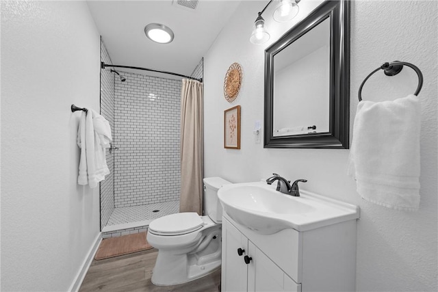 full bath with visible vents, toilet, a stall shower, wood finished floors, and vanity