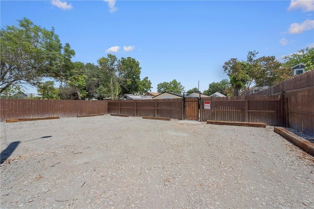 view of yard featuring a gate and fence