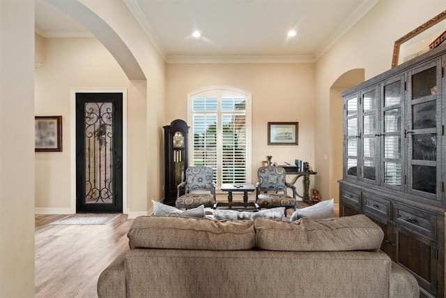 living room featuring light wood-type flooring and ornamental molding