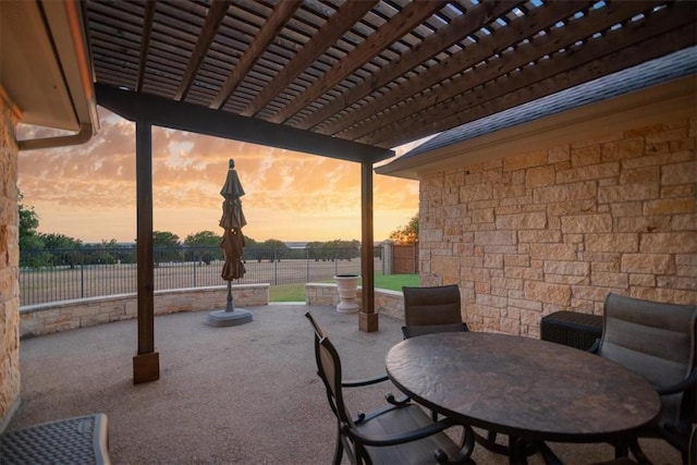 patio terrace at dusk featuring a pergola