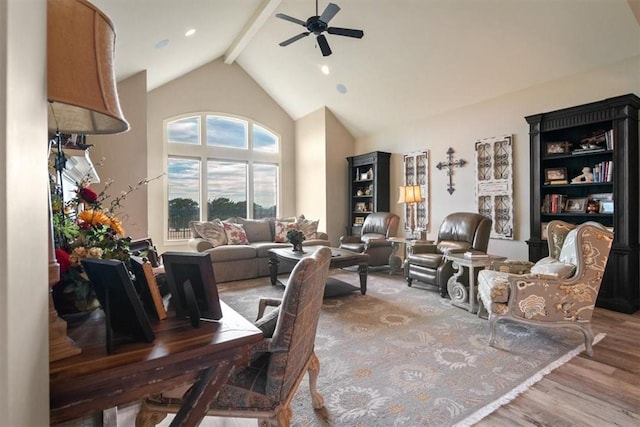 living room featuring beamed ceiling, hardwood / wood-style floors, high vaulted ceiling, and ceiling fan