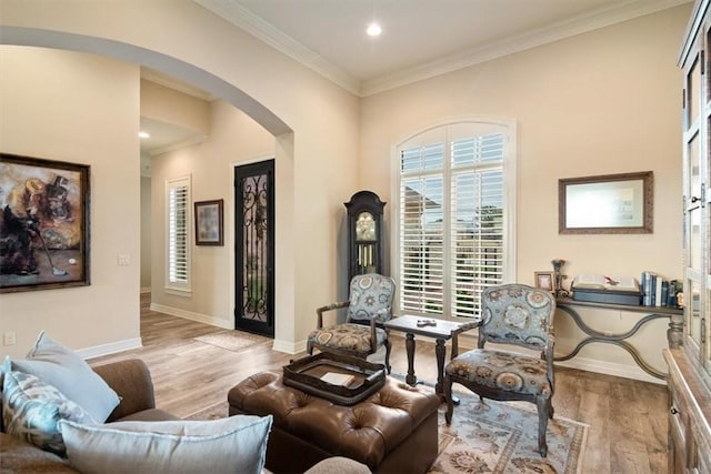 living room with light wood-type flooring and crown molding