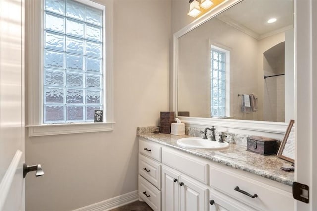 bathroom featuring vanity and ornamental molding