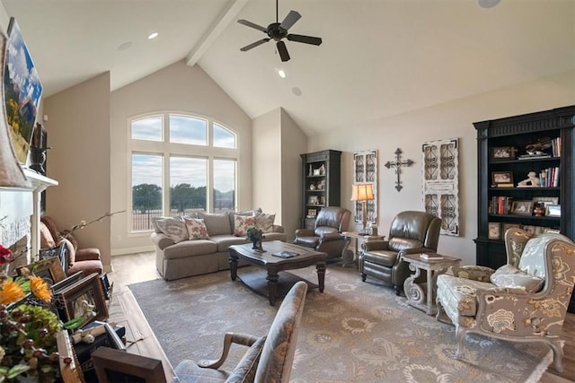 living room featuring beamed ceiling, ceiling fan, and high vaulted ceiling