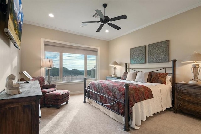 carpeted bedroom featuring ceiling fan and crown molding