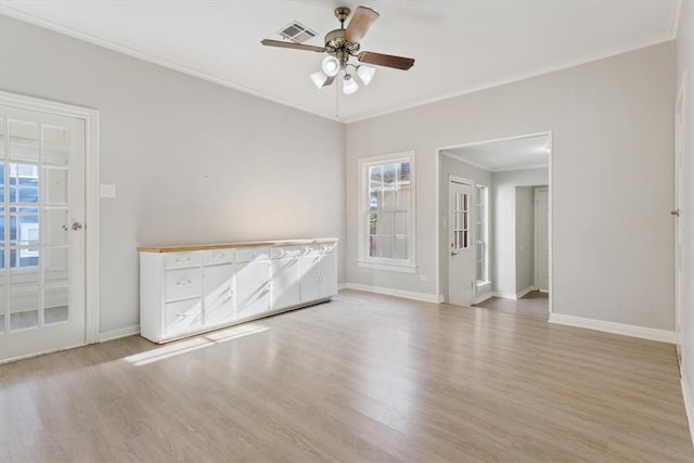 empty room with ceiling fan, light hardwood / wood-style floors, and crown molding