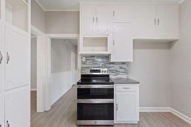 kitchen featuring white cabinetry, electric stove, and crown molding