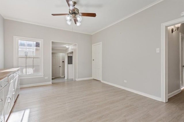 unfurnished living room featuring a wealth of natural light, light hardwood / wood-style floors, ceiling fan, and crown molding