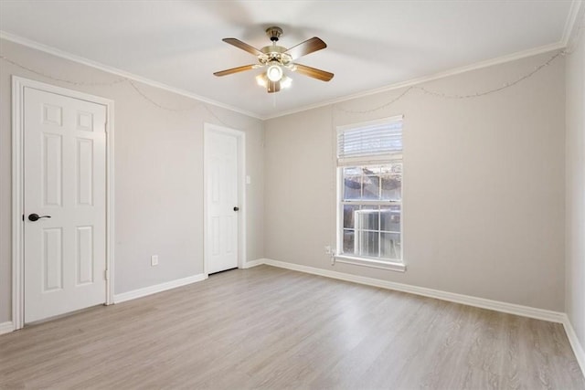 spare room featuring light hardwood / wood-style floors, ceiling fan, and ornamental molding