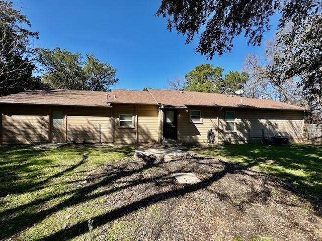 rear view of property with a lawn