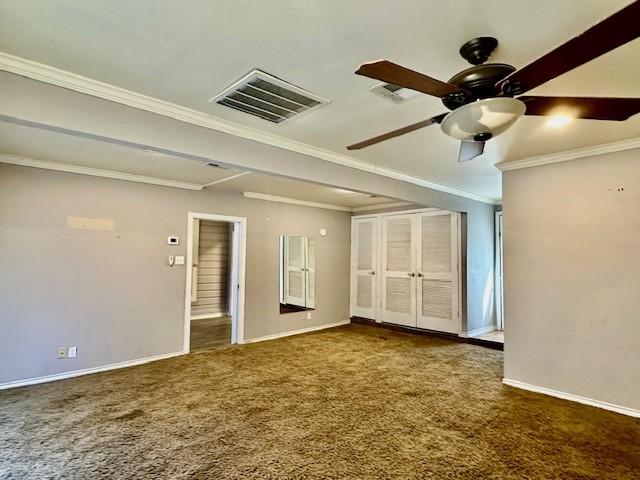 carpeted empty room featuring ceiling fan and crown molding