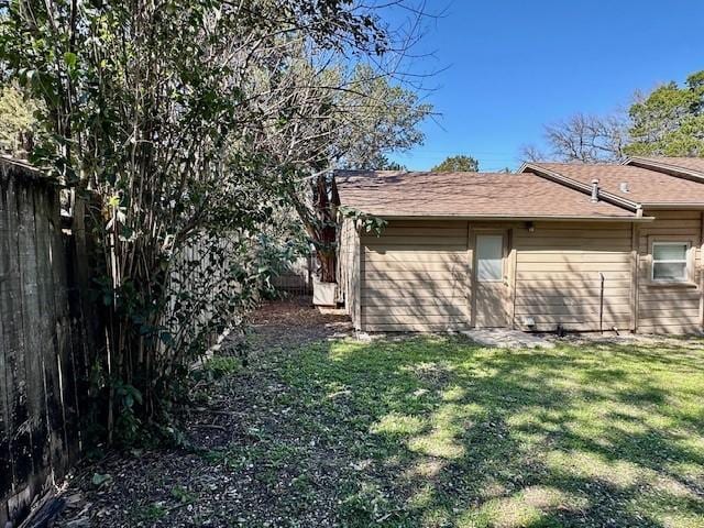 view of side of home featuring a yard