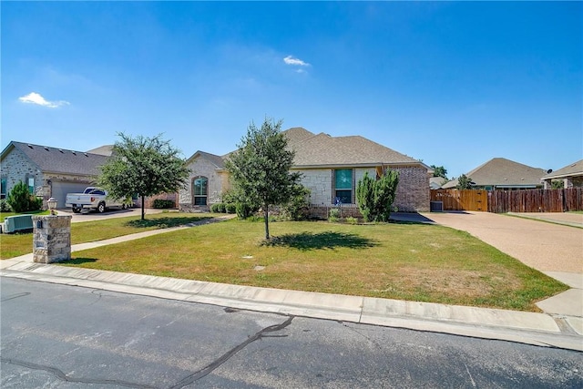 view of front of property featuring a front yard and a garage